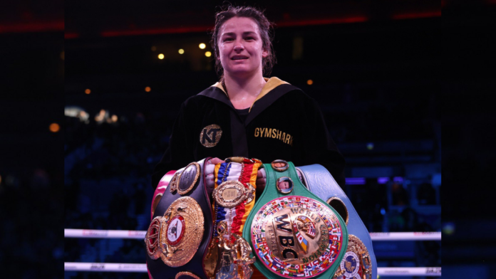 Katie Taylor with her belts after defeating Kazakhstan’s Firuza Sharipova Saturday (Matchroom)